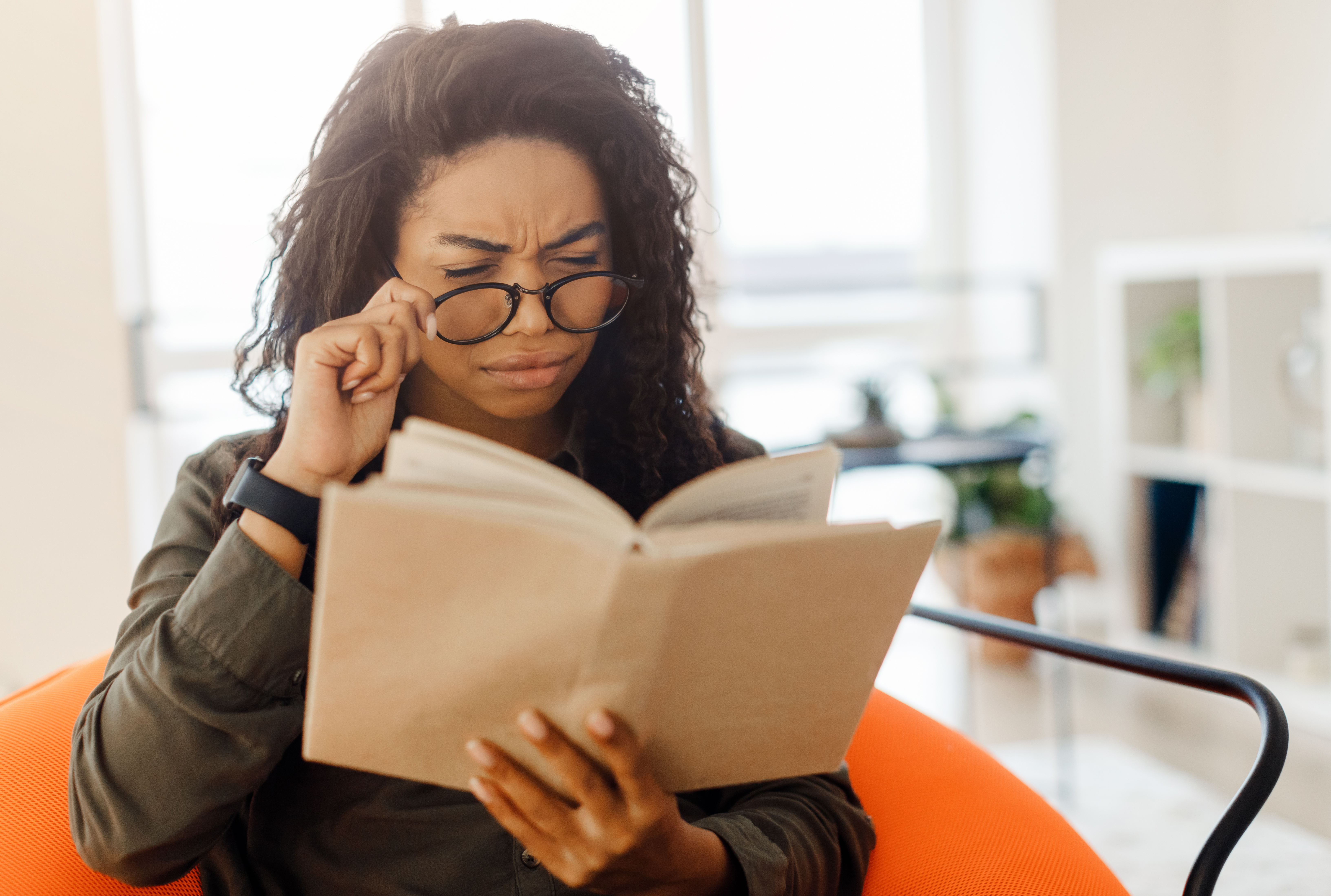 Woman trying prescription glasses on a laptop